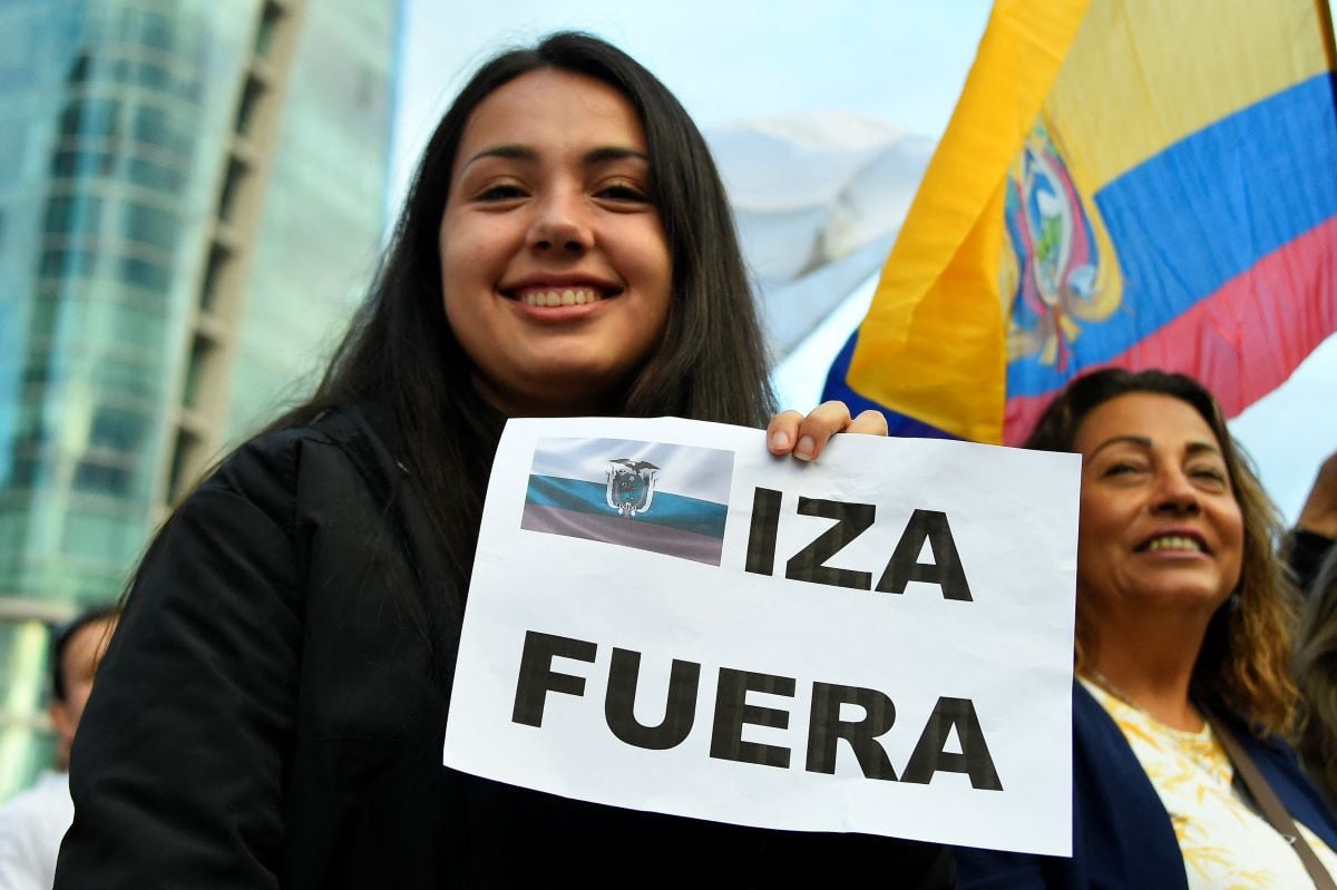 A government supporter holds up a sign that reads 