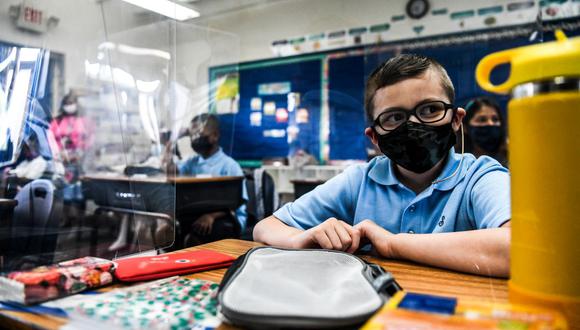 Los estudiantes usan mascarillas cuando asisten a su primer día de escuela después de las vacaciones de verano en Miami, el 18 de agosto de 2021. (CHANDAN KHANNA / AFP).