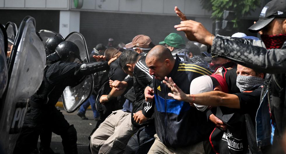 Miembros de organizaciones sociales se enfrentan a la policía durante una manifestación contra las recientes medidas económicas introducidas por el gobierno del presidente Javier Milei en Argentina. (Foto de LUIS ROBAYO / AFP).