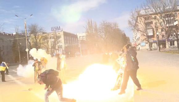 Los manifestantes reaccionan a las granadas de aturdimiento lanzadas por las tropas rusas mientras protestan por la invasión rusa, a lo largo de la avenida Ushakova en Kherson, Ucrania. (Foto: REUTERS).