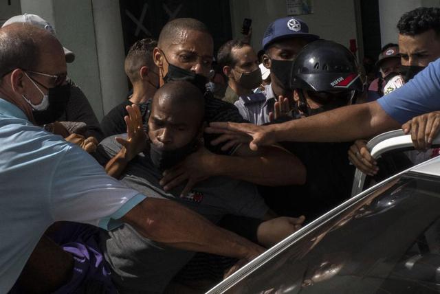 Cientos de manifestantes salieron a las calles de varias ciudades de Cuba para protestar contra la actual escasez de alimentos y los altos precios. En la imagen, la policía detiene a un opositor. (Foto AP / Ramón Espinosa).