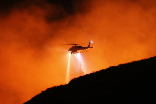 A helicopter drops water as the Rabbit Fire burns in Moreno Valley, Riverside County, California on July 14, 2023.  (Photo: AFP)