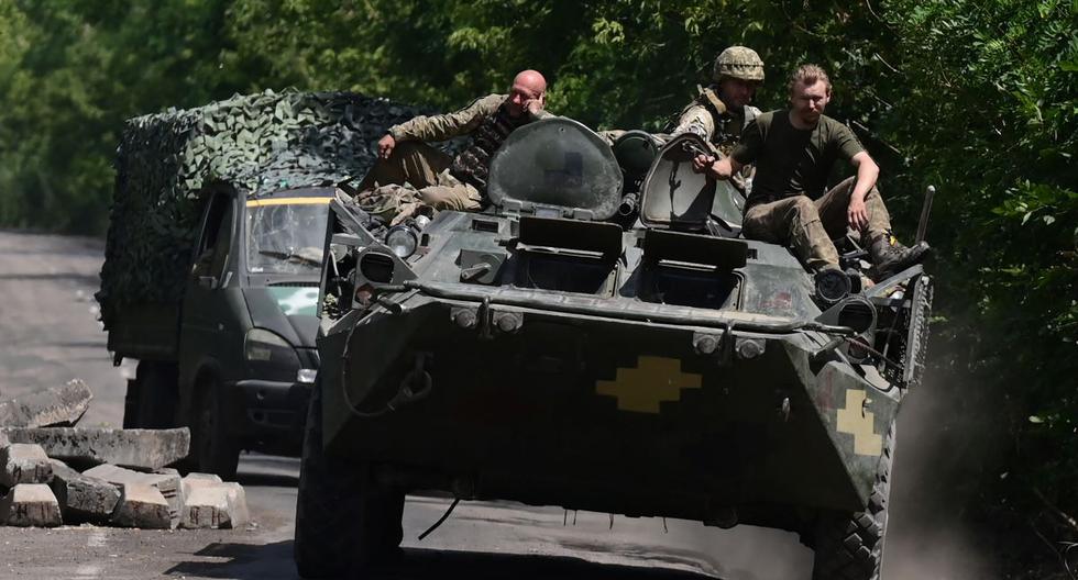 Soldados ucranianos viajan sentados en un vehículo blindado por una carretera en el este de Ucrania, en medio de la invasión rusa. el 9 de julio de 2022. (AFP).