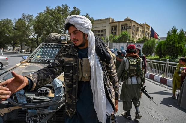 Taliban fighters stand guard along a street at the Massoud Square in Kabul on August 16, 2021. (Photo by Wakil Kohsar / AFP)