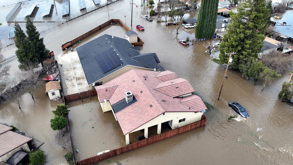 This aerial view shows flooded homes in Planada, California, as a flood continues. 