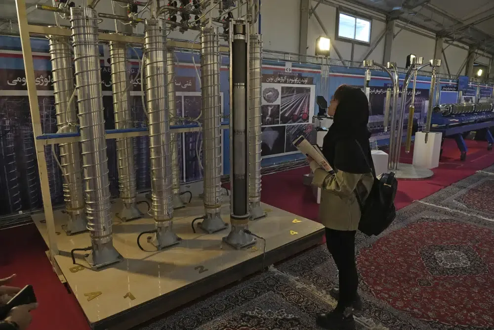 A student watches Iran's homemade centrifuges at a display of the country's nuclear achievements, Wednesday, Feb. 8, 2023. (AP Photo/Vahid Salemi)