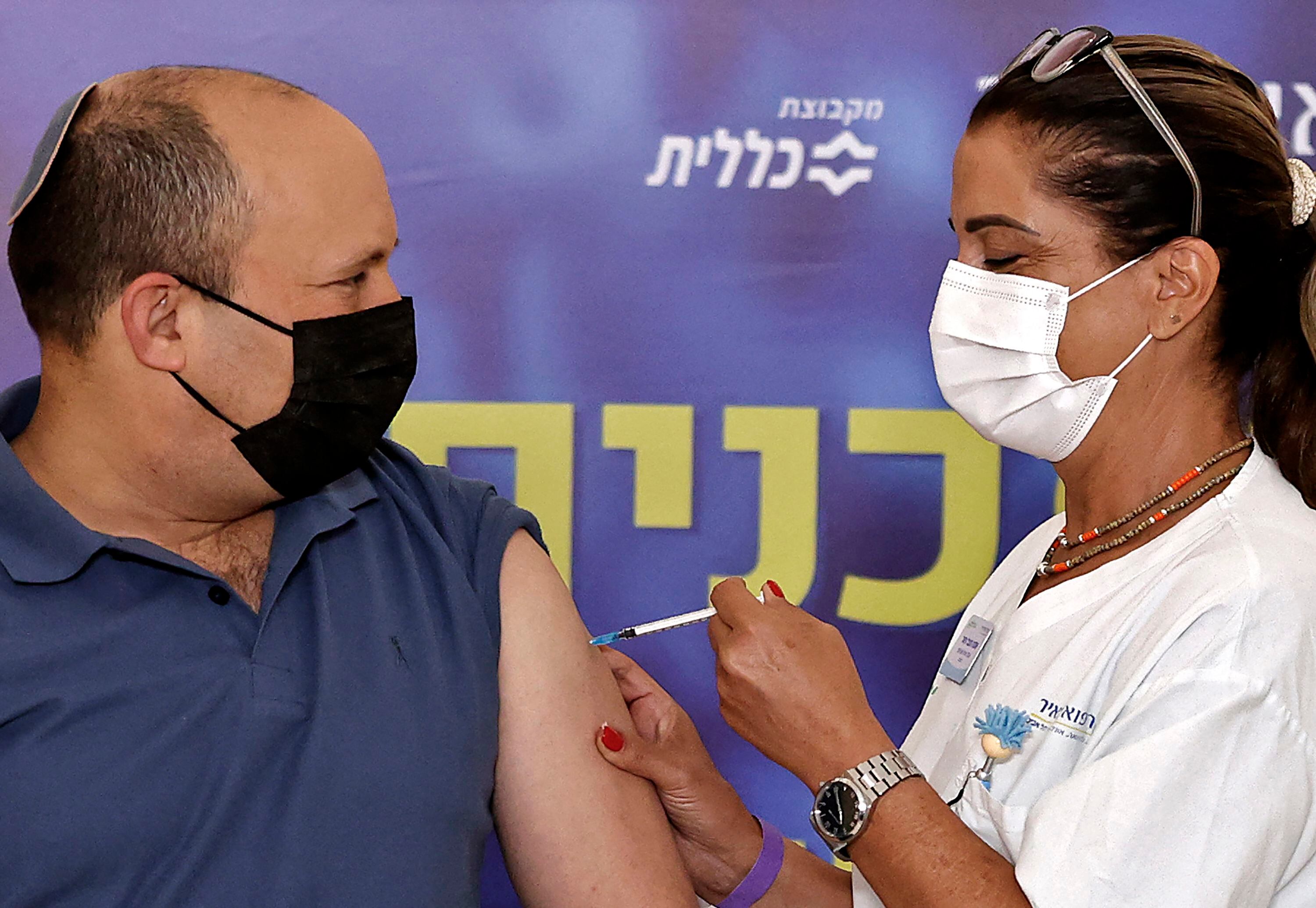 Israeli Prime Minister Naftali Bennett receives a booster injection of the coronavirus vaccine at the Meir Medical Center in the central Israeli city of Kfar Saba on August 20.  (Photo: AFP)