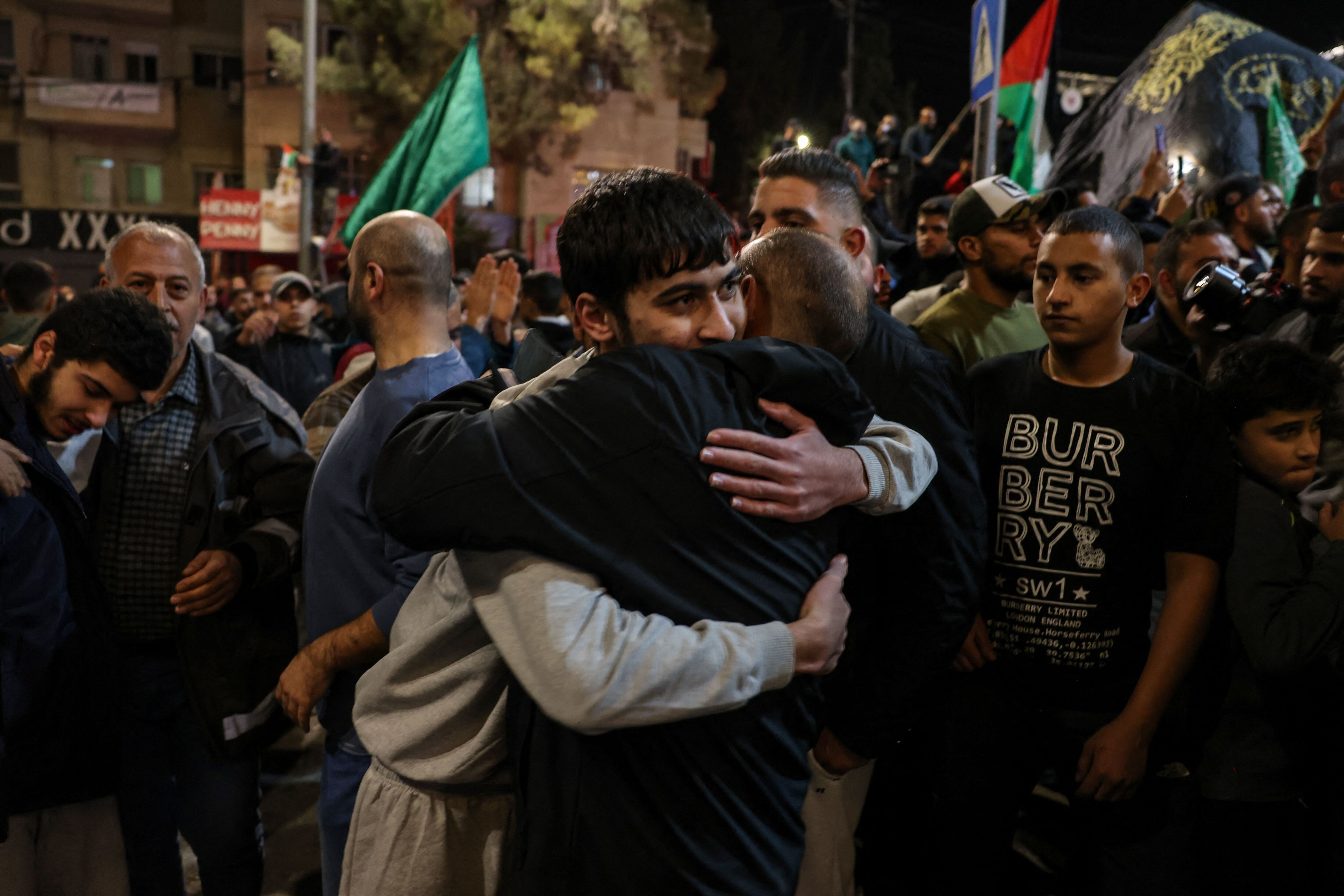 A Palestinian prisoner is welcomed to the West Bank by a family member after being released from Israeli prisons in exchange for hostages released by Hamas.  (Photo by AHMAD GHARABLI/AFP).