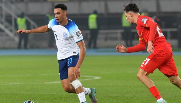 England's defender #10 Trent Alexander-Arnold (L) controls the ball in front of North Macedonia's midfielder #21 Jani Atanasov during the UEFA Euro 2024 group C qualification football match between North Macedonia and England at National Arena "Todor Proeski" in Skopje on November 20, 2023. (Photo by Robert ATANASOVSKI / AFP)