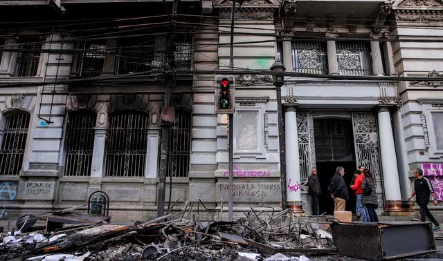 Decenas de manifestantes incendiaron la noche del sábado el edificio de El Mercurio del puerto de Valparaíso, el diario en circulación más antiguo de Chile. (AFP / JAVIER TORRES).
