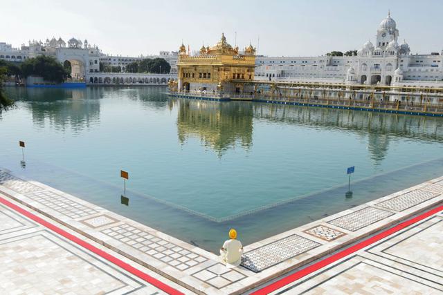 Un devoto sij presenta sus respetos en el Templo Dorado durante un toque de queda en India. (Foto: AFP)