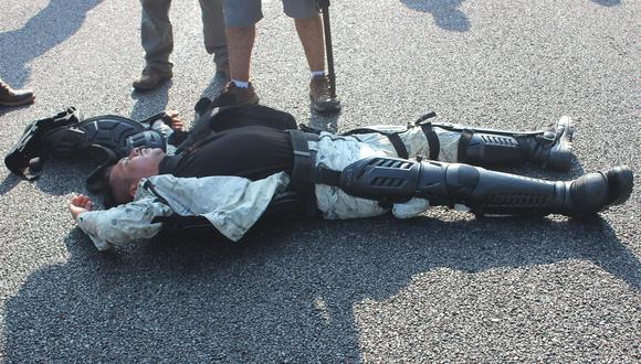 Un integrante de la Guardia Nacional de México permanece en el suelo después de un enfrentamiento con migrantes en Pijijiapan, Chiapas. (EFE/Juan Manuel Blanco).