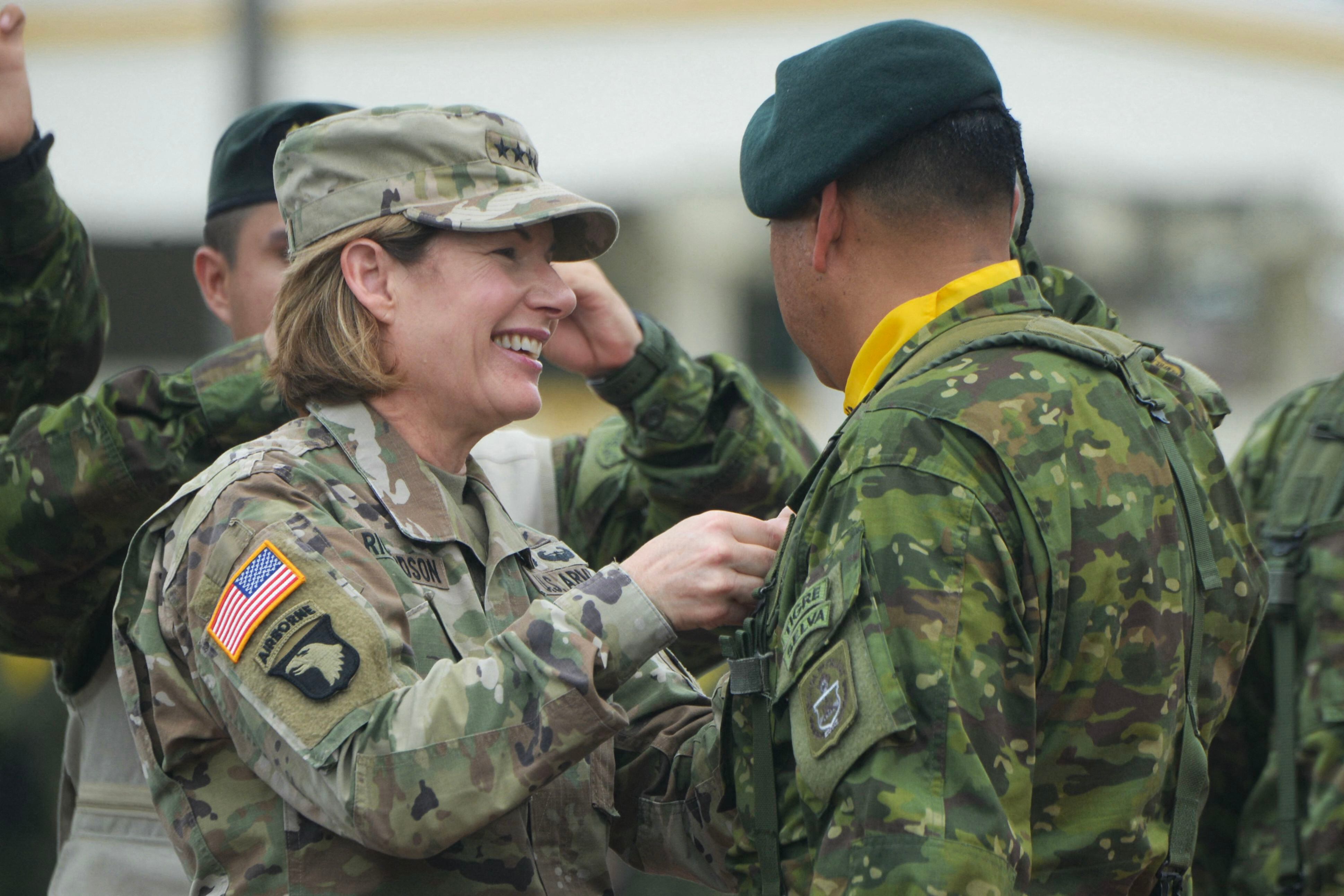 The head of the United States Southern Command, Laura Richardson, presents a decoration to an Ecuadorian soldier during his visit to the Huancavilca military fort, in Guayaquil, on January 25, 2024. (Photo by Gerardo MENOSCAL/AFP).