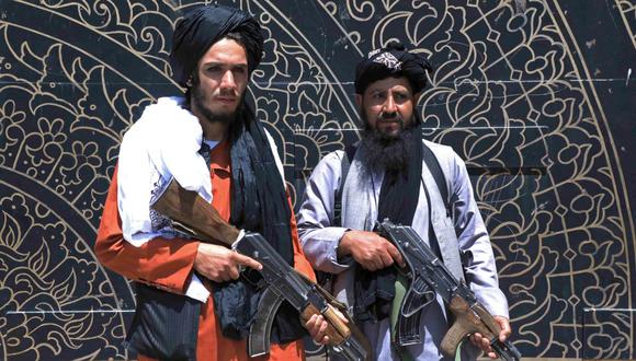 Dos combatientes talibanes montan guardia frente a la oficina del gobernador provincial en Herat, Afganistán, el 14 de agosto de 2021. (Foto: AFP).