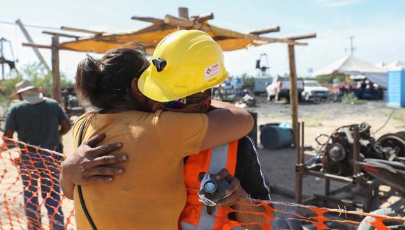 Sergio Martínez Valdés, hermano de uno de los mineros, se abraza con su esposa. (LUIS CORTES/REUTERS)