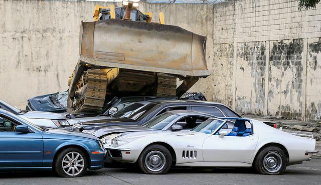A bulldozer destroys condemned smuggled luxury cars worth 61,626,000.00 pesos (approximately US$1.2 million), which include used Lexus, BMW, Mercedes-Benz, Audi, Jaguar and Corvette Stingray, during the 116th Bureau of Customs founding anniversary in Metro Manila, Philippines February 6, 2018. REUTERS/Romeo Ranoco