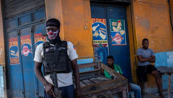 Un oficial de la Policía Nacional de Haití monta guardia cerca del área controlada por pandillas en Morne A Tuff. (Ricardo ARDUENGO / AFP).