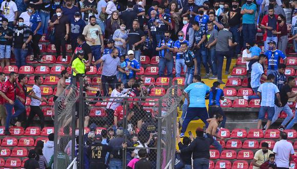 Aficionados del Querétaro y aficionados del Atlas originaron un conato de pelea que terminó invadiendo la cancha. (Foto: EFE)