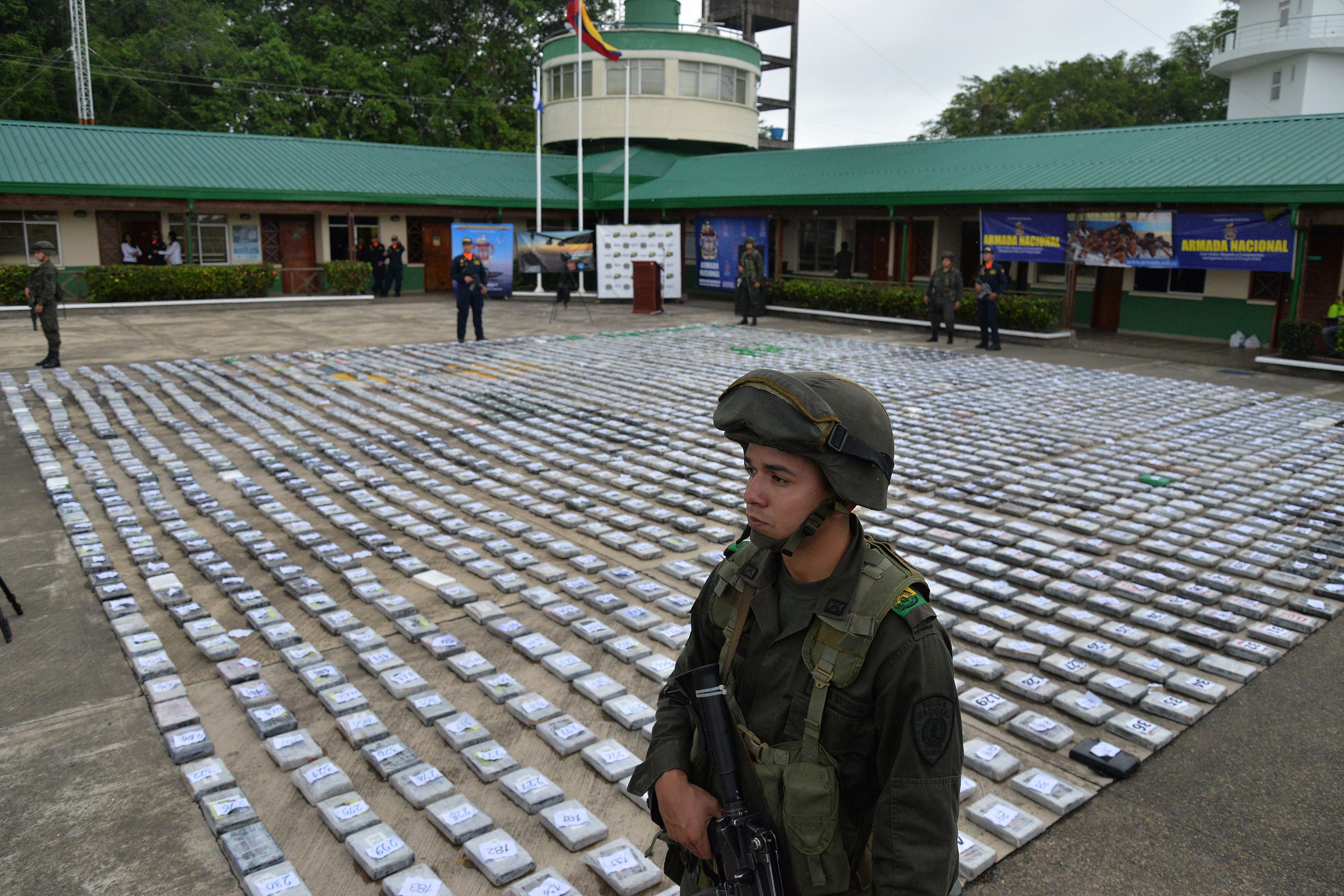 A Colombian police officer stands guard next to packets of cocaine being shown to the press in Turbo, Antioquia department, Colombia.