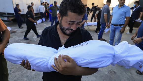 Un palestino reacciona mientras sostiene el cuerpo de un familiar muerto tras un bombardeo de Israel, durante un funeral en Deir Al-Balah, en el centro de la Franja de Gaza, el 31 de octubre de 2023. (Foto de Mahmud HAMS / AFP).
