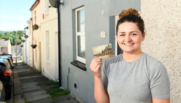 Michaela Webber posa sonriente con la postal que recibió en su casa. (Penny Cross / Plymouth Herald)