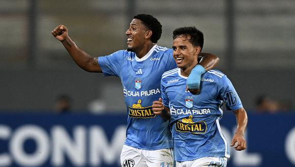 Sporting Cristal's defender Jhilmar Lora (R) celebrates with midfielder Jesus Castillo after scoring against Nacional during the second leg Copa Libertadores second stage football match between Peru's Sporting Cristal and Paraguay's Nacional, at the National stadium in Lima, on February 28, 2023. (Photo by ERNESTO BENAVIDES / AFP)