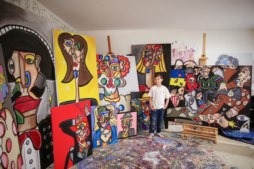 Andrés Valencia in his studio, surrounded by his paintings.  (ELSA VALENCIA).