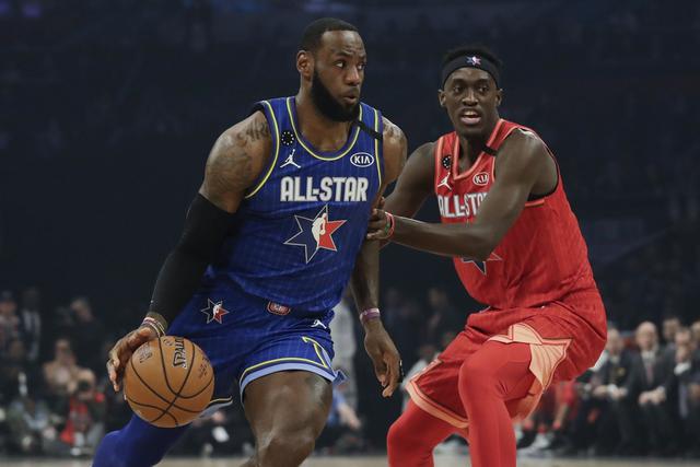LeBron James of the Los Angeles Lakers dribbles past Pascal Siakam of the Toronto Raptors during the first half of the NBA All-Star basketball game Sunday, Feb. 16, 2020, in Chicago. (AP Photo/Nam Huh)