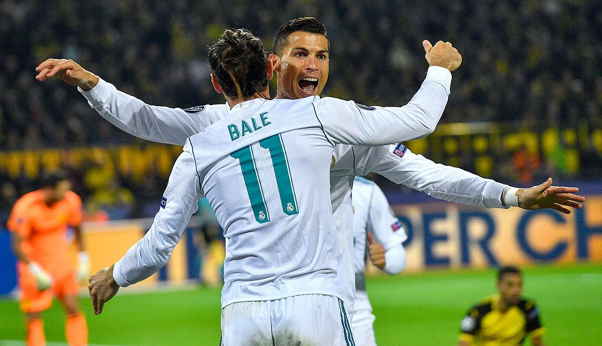 Real Madrid's scorer Cristiano Ronaldo, rear, and his teammate Gareth Bale, front, celebrate their side's 2nd goal during the Champions League group H soccer match between Borussia Dortmund and Real Madrid CF in Dortmund, Germany, Tuesday, Sept. 26, 2017. (AP Photo/Martin Meissner)