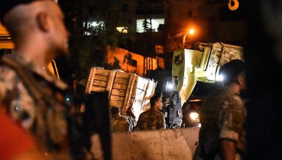 Soldados del ejército libanés descargan cajas de un camión en la ciudad de Kahale, tras un enfrentamiento entre miembros del grupo Hezbolá respaldado por Irán y residentes de la ciudad cristiana el 9 de agosto de 2023. (Foto de AFP)