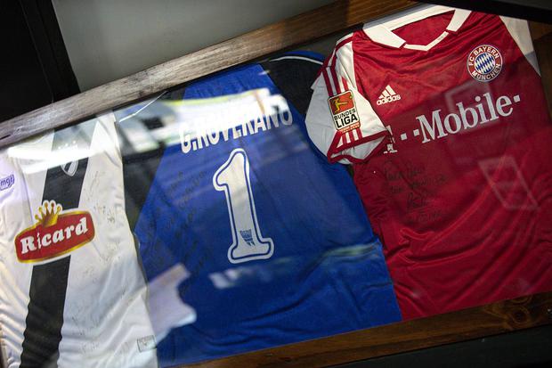 Pablo Propumo has a collection of about 100 shirts signed by soccer stars, many of which are on display in his store. 