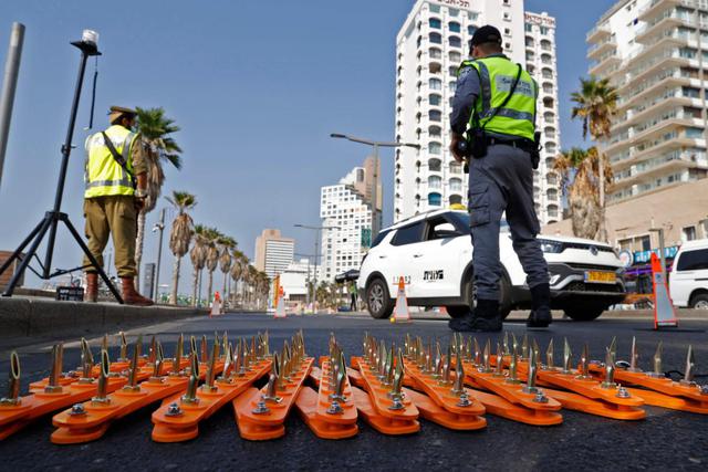 La policía es vista en un puesto de control en la ciudad costera de Tel Aviv. Esto sucede en medio de la entrada en vigor de una cuarentena total por el coronavirus en Israel. (AFP / JACK GUEZ).