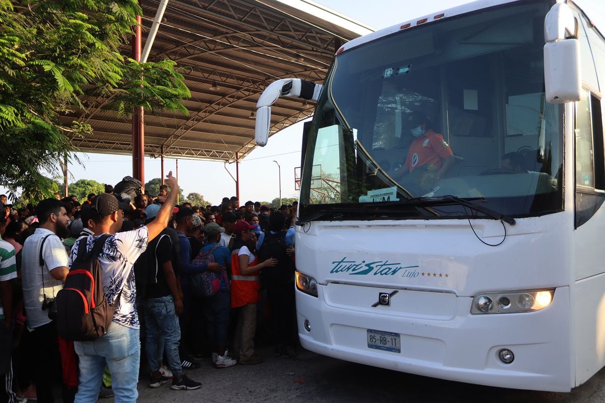 Migrants board a bus from the National Migration Institute (INM) after ending a caravan bound for the United States, in the municipality of Mapastepec, state of Chiapas, Mexico, on January 2, 2023. (Photo by Juan Manuel Blanco/EFE)