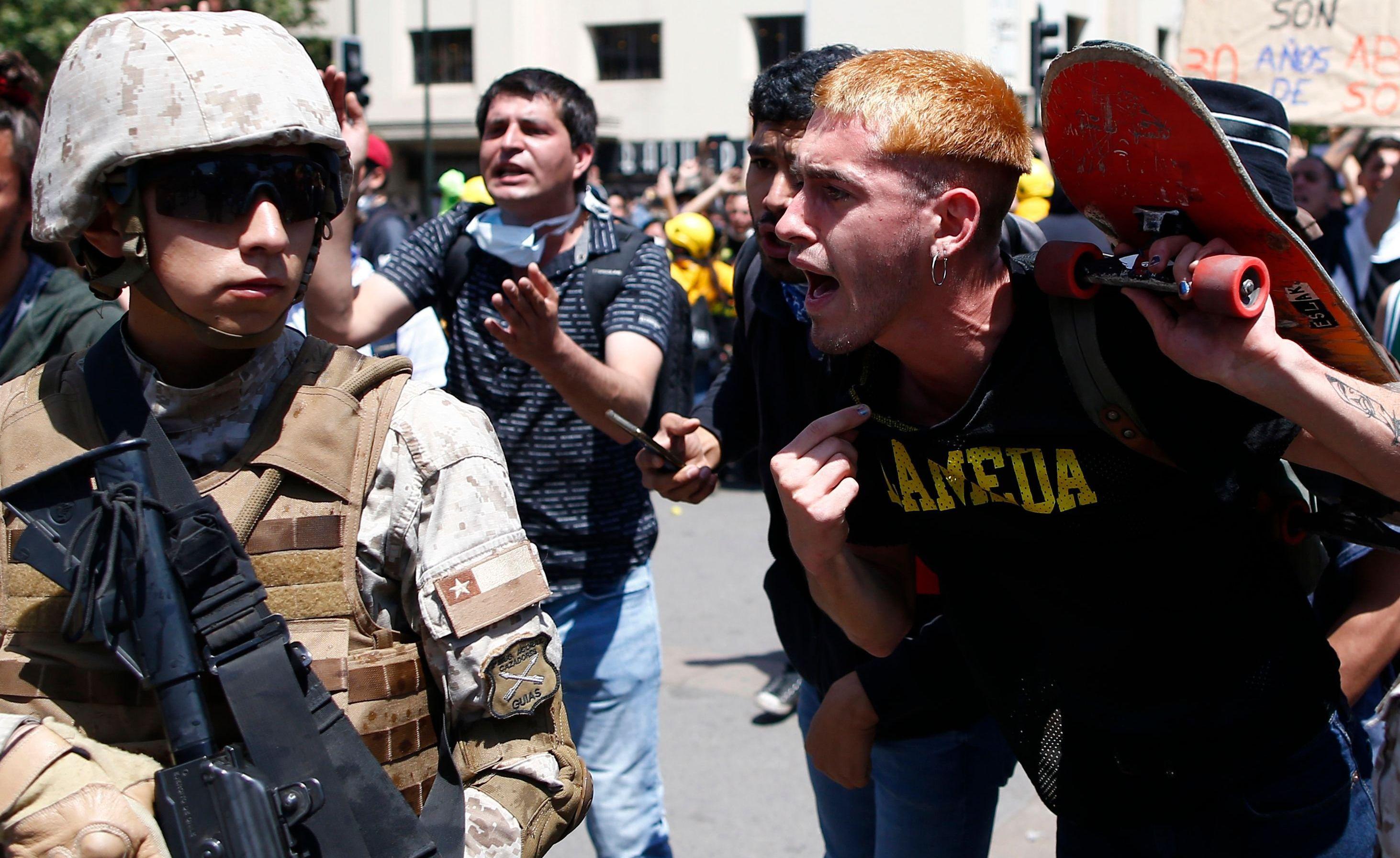 Un manifestante encara a un soldado durante una protestas en Santiago. (AFP / Pablo VERA).