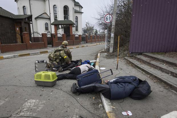 A family fleeing from Irpin, Ukraine, was hit by Russian mortar fire on Sunday, March 6, 2022. (AP Photo/Diego Herrera Carcedo)