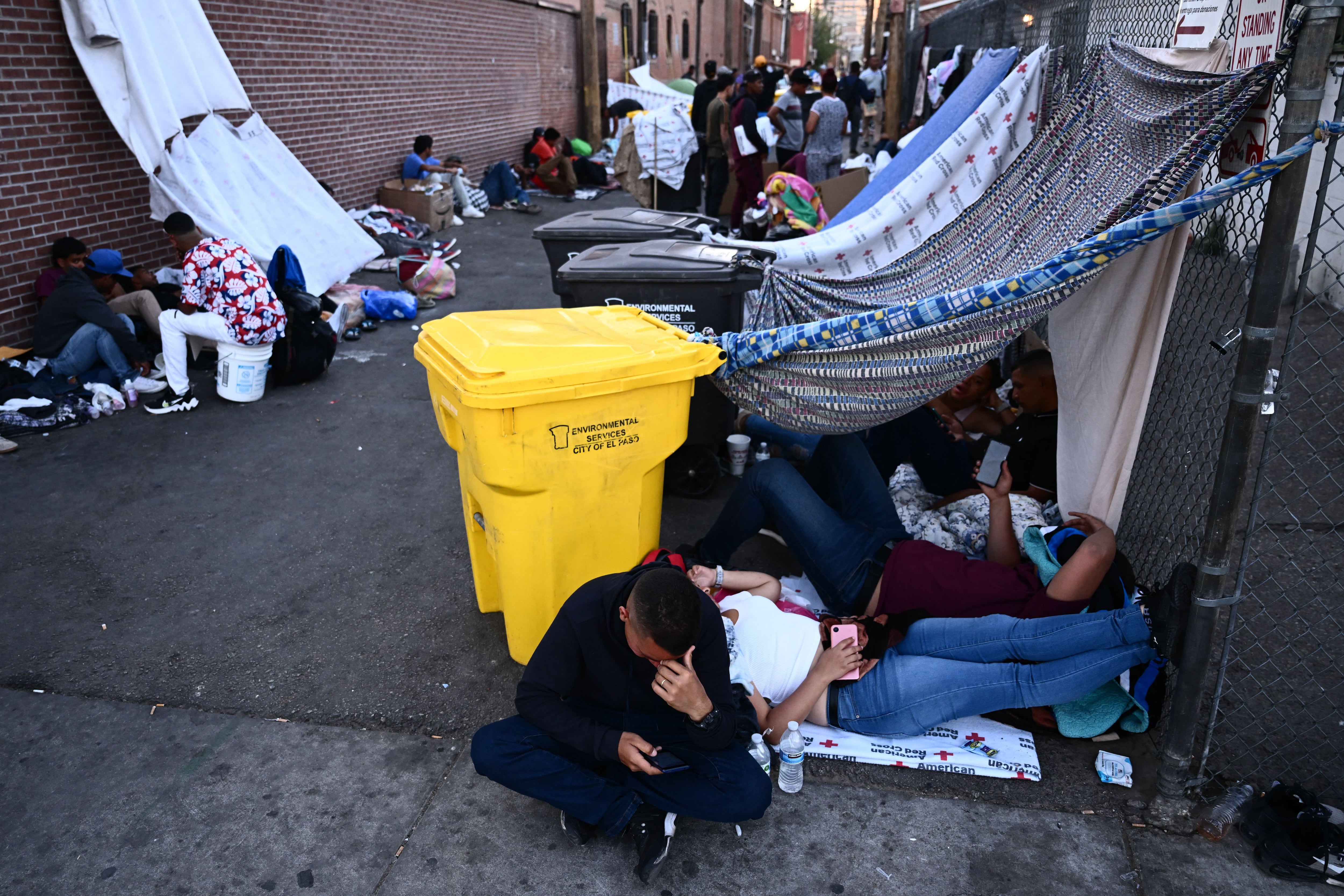 Migrants camp near Sacred Heart Church in downtown El Paso, Texas, on May 8, 2023. (Photo by Patrick T. Fallon / AFP)