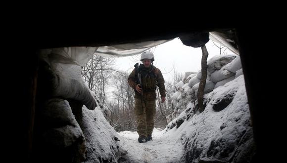 Un militar de Ucrania camina a lo largo de una trinchera cubierta de nieve en la línea del frente con los separatistas respaldados por Rusia cerca de la aldea de Zolote, en la región oriental de Lugansk, el 21 de enero de 2022. (ANATOLII STEPANOV / AFP).