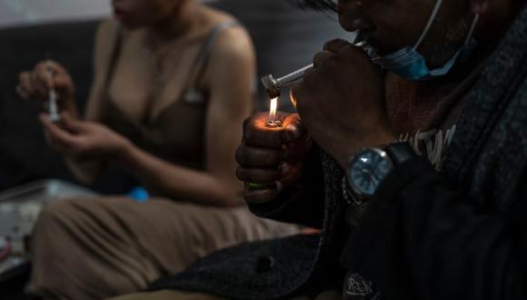 Un hombre fuma fentanilo en polvo mientras su pareja prepara una dosis para inyectar, en Tijuana, México, el 10 de mayo de 2023. (Foto de GLADYS SERRANO / EL PAÍS)