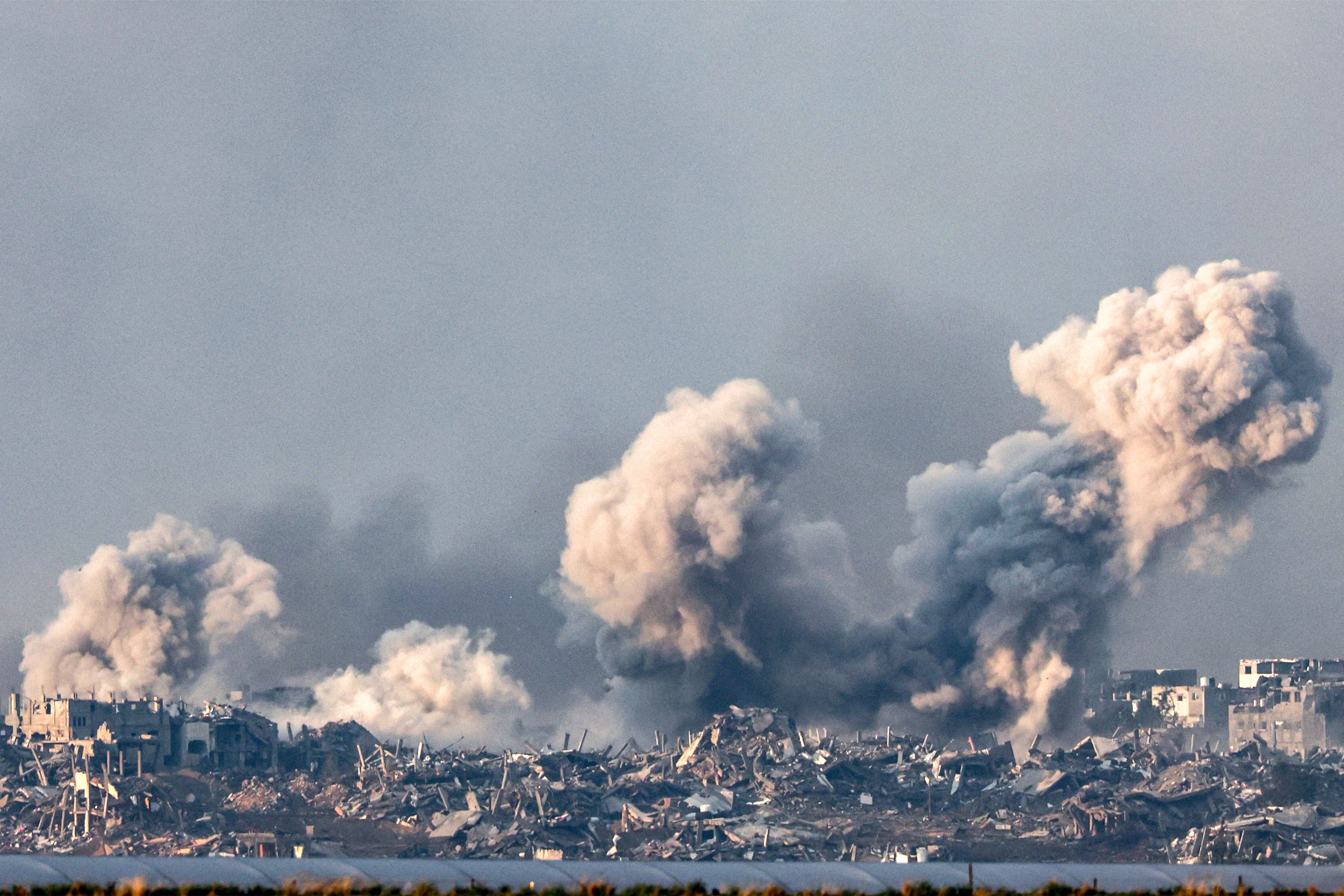 Smoke rises over the northern Gaza Strip during an Israeli bombardment on December 14, 2023. (Photo by JACK GUEZ/AFP).