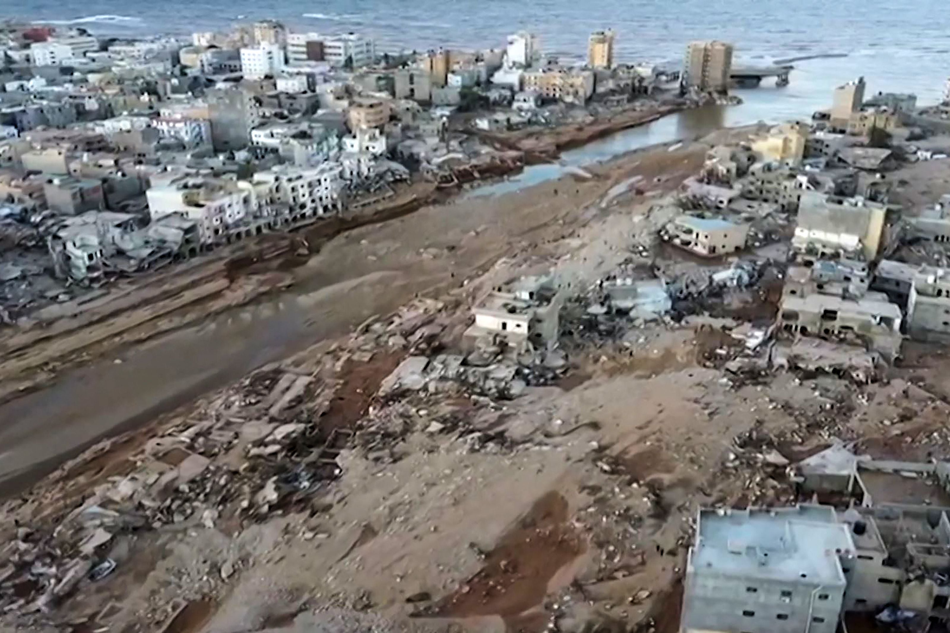 This image taken from AFPTV footage shows an aerial view of flood damage in Derna in eastern Libya.  (Photo by AFPTV/AFP).