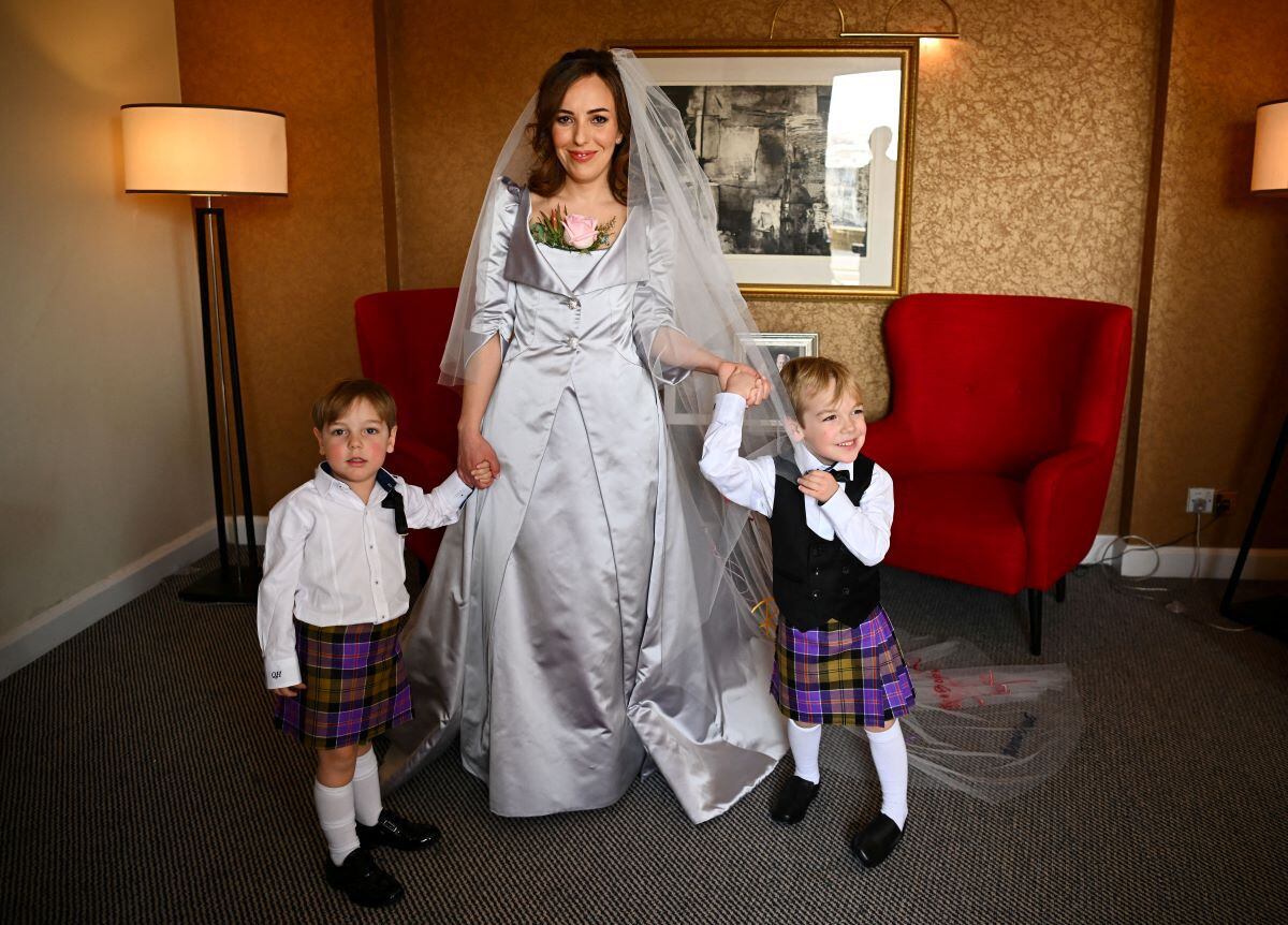 Stella Moris poses in her wedding dress designed by Vivienne Westwood.  (DYLAN MARTINEZ / AFP).