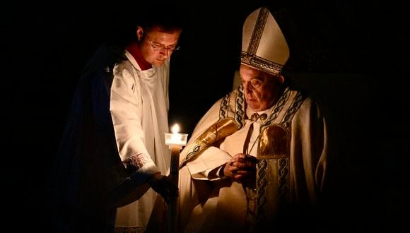 El papa Francisco mira su vela durante la vigilia pascual como parte de las celebraciones de Semana Santa, en la Basílica de San Pedro en el Vaticano el 30 de marzo de 2024. (Foto de Tiziana FABI / AFP)