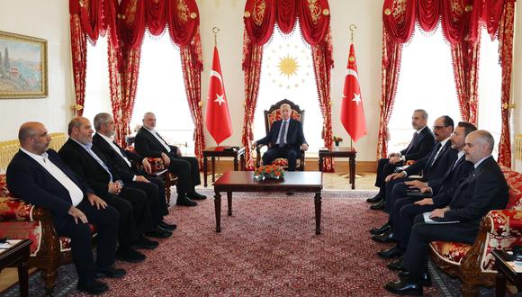 El presidente turco Recep Tayyip Erdogan (C) reuniéndose con Ismail Haniyeh (4thL), el líder político del movimiento palestino Hamás, y sus delegaciones en la sede presidencial de Dolmabahce. (Foto de Handout / SERVICIO DE PRENSA PRESIDENCIAL TURCO / AFP)