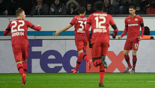 Leverkusen's Italian forward Lucas Alario (R) and his team mates celebrate a goal during their Europa League last 32 First Leg soccer match between Bayer Leverkusen v FC Porto, western Germany on February 20, 2020.  / AFP / Ina FASSBENDER