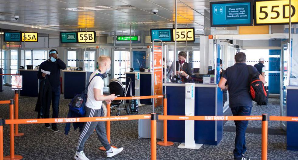 Los pasajeros adoptan una distancia social segura mientras hacen fila para abordar un vuelo de pasajeros operado por Easyjet Plc en el aeropuerto de Gatwick de Londres en Crawley, Reino Unido. (Foto: Jason Alden / Bloomberg).