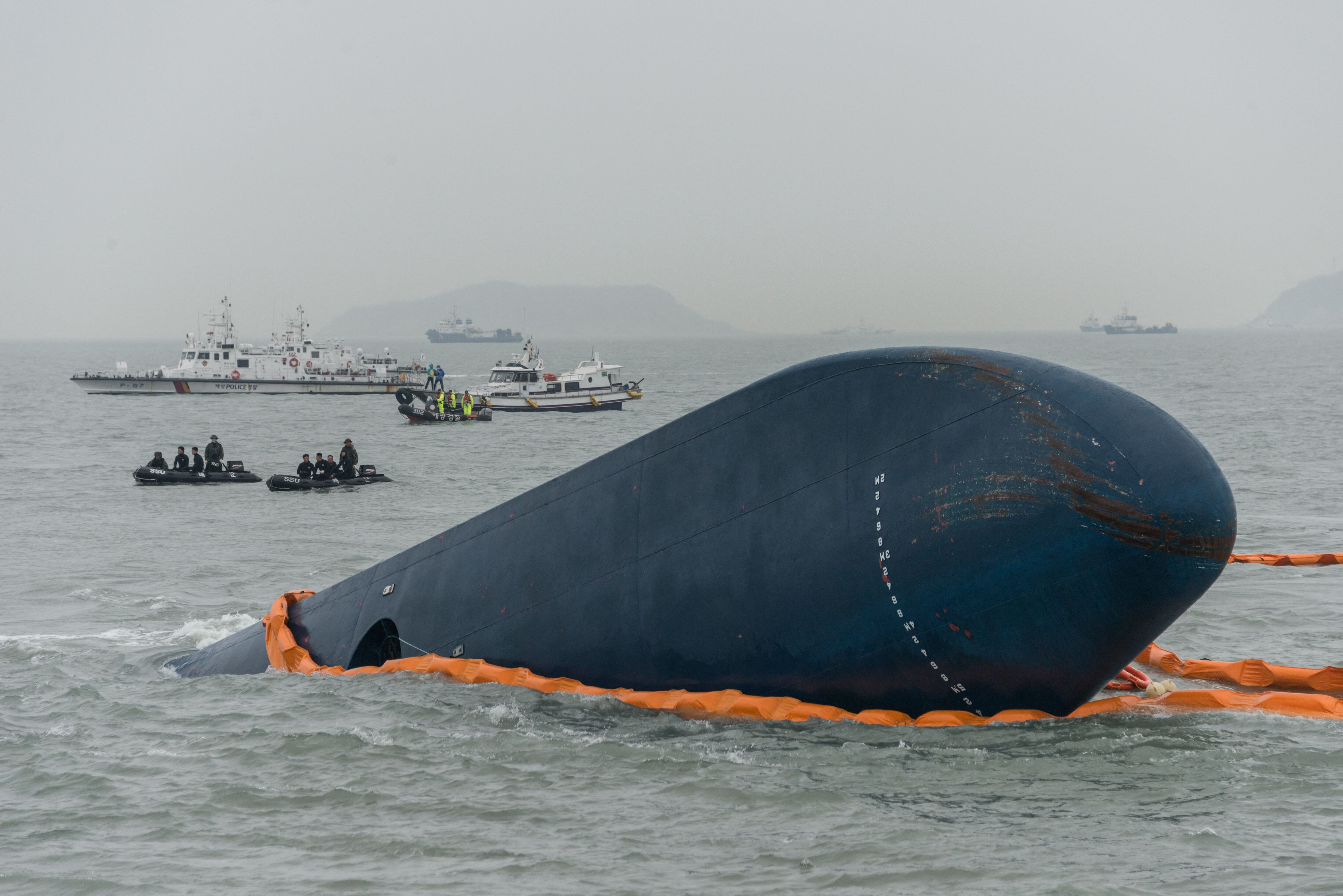 In a photo taken April 17, 2014, Coast Guard and rescue boats surround the Sewol's overturned hull.  (Photo by Ed Jones/AFP).
