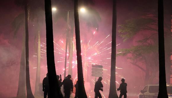Fuegos artificiales estallan durante los enfrentamientos con la policía en Le Port, isla francesa de La Reunión en el Océano Índico, el 30 de junio de 2023. (Foto de Richard BOUHET / AFP)