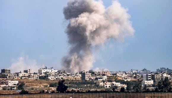 Una columna de humo de una explosión se eleva en la Franja de Gaza, vista desde una posición a lo largo de la frontera sur de Israel con el territorio palestino el 13 de mayo de 2024, en medio del conflicto en curso entre Israel y el grupo militante Hamas. (Foto de JACK GUEZ / AFP)