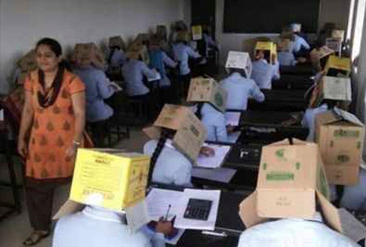 Escuela causa polémica por colocar cajas de cartón en la cabeza de los alumnos para que no copien. (@Francis_Joseph)