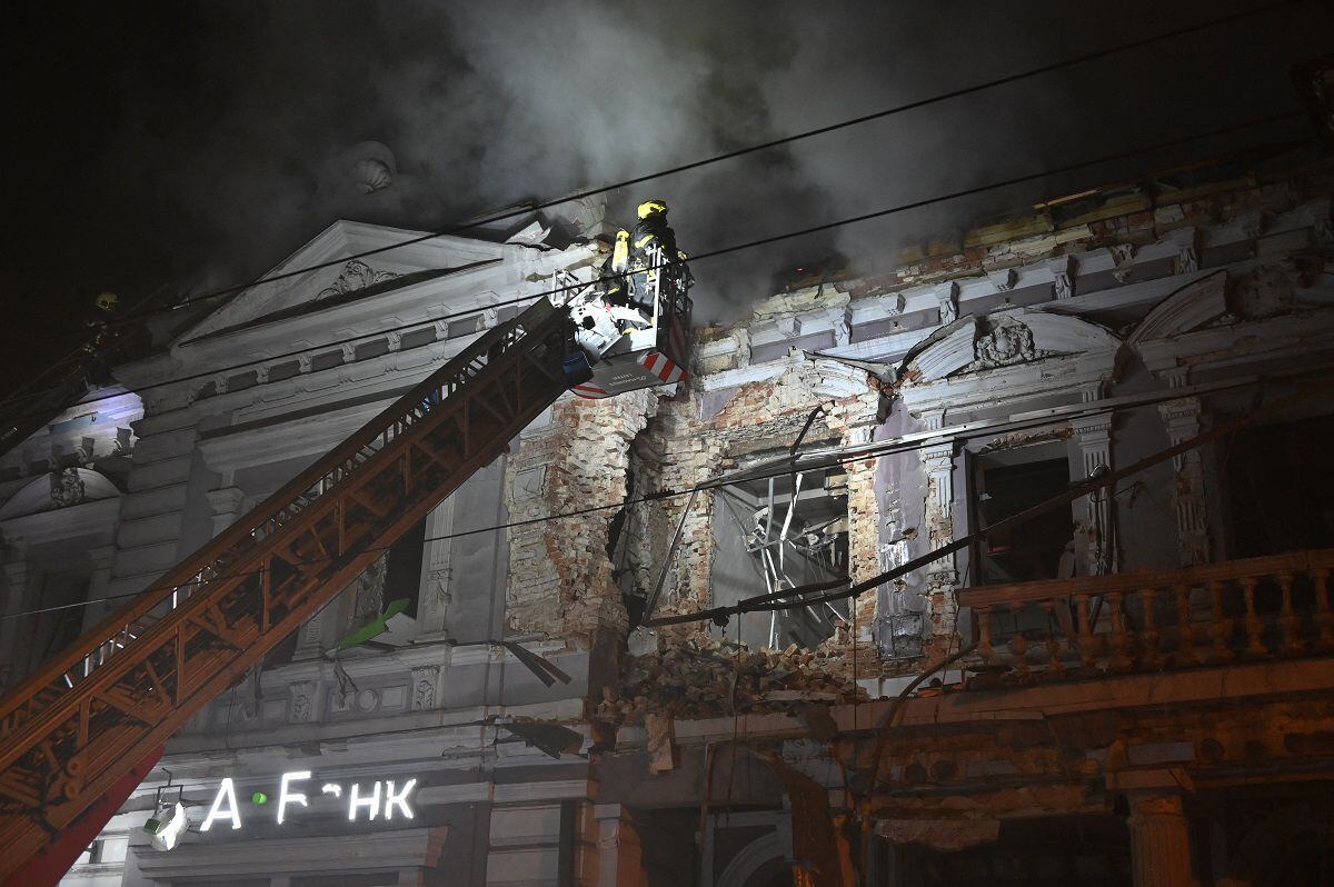 Firefighters extinguish a fire in a building following a Russian drone strike in Kharkiv on December 31, 2023, amid Russia's invasion of Ukraine.  (Photo by SERGEY BOBOK/AFP)